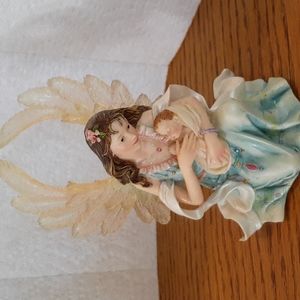 Pretty Angel holding a baby